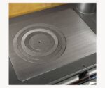 Detailed view of a cast iron stove plate with concentric circles.