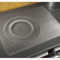 Detailed view of a cast iron stove plate with concentric circles.