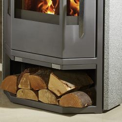 The picture shows a gray stove with natural stone elements. The focus is on the lower section, where there is a wood compartment filled with several logs. The stove offers an attractive combination of modern design and practical wood storage, ideal for a cozy ambience.