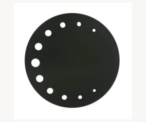 The picture shows a round, black top plate of the Filou2 tiled stove. The plate has several decorative, differently sized holes along an arc near the edge. This spare part component is made of robust material and can contribute to the visual enhancement and functionality of the stove. Ideal for customizing the look of your wood-burning stove.