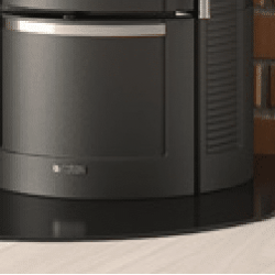 De afbeelding toont het houtvak van een houtkachel. De houtkachel heeft een modern, donker metalen ontwerp en het houtvak bevindt zich onderaan de kachel. Het vak is handig voor het opbergen van brandhout en past bij het stijlvolle totaalbeeld van de houtkachel. Ideaal voor efficiënter verwarmen en voor het organiseren van het brandhout thuis.